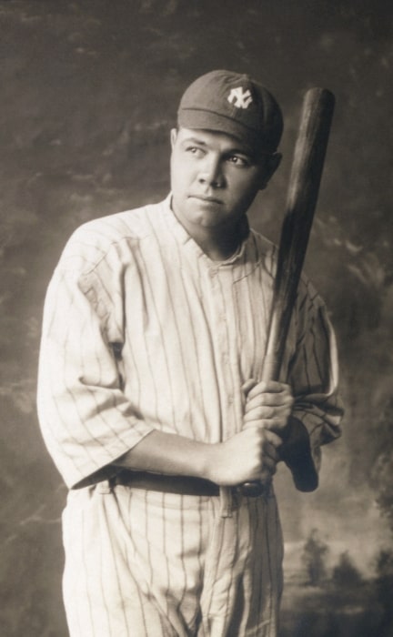 Babe Ruth as seen while wearing baseball uniform and holding a baseball bat in 1920