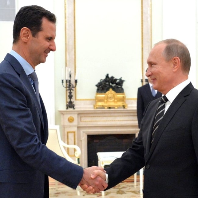 Bashar al-Assad (Left) as seen while meeting President Vladimir Putin of Russia in Moscow, Russia to discuss the military operations in Syria in October 2015