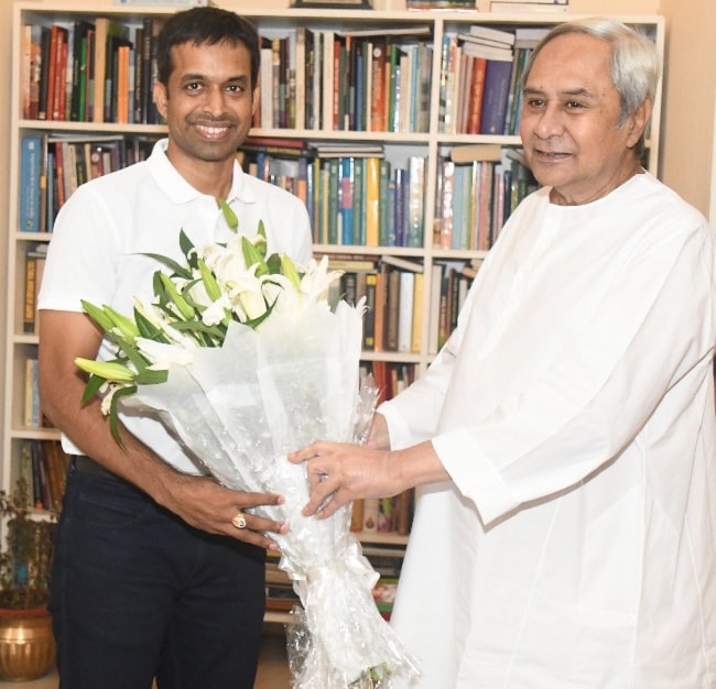 Pullela Gopichand (Left) as seen while smiling for the camera with CM Naveen Patnaik in 2018