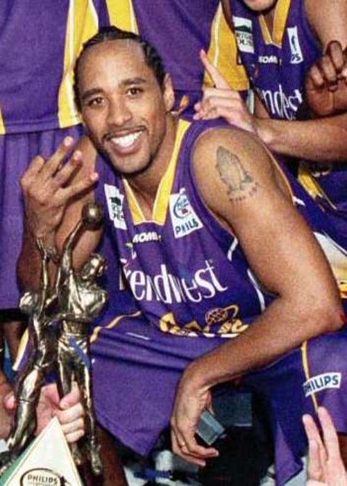 C. J. Bruton as seen while smiling for the camera as he celebrates the 2005 NBL championship win with the Sydney Kings