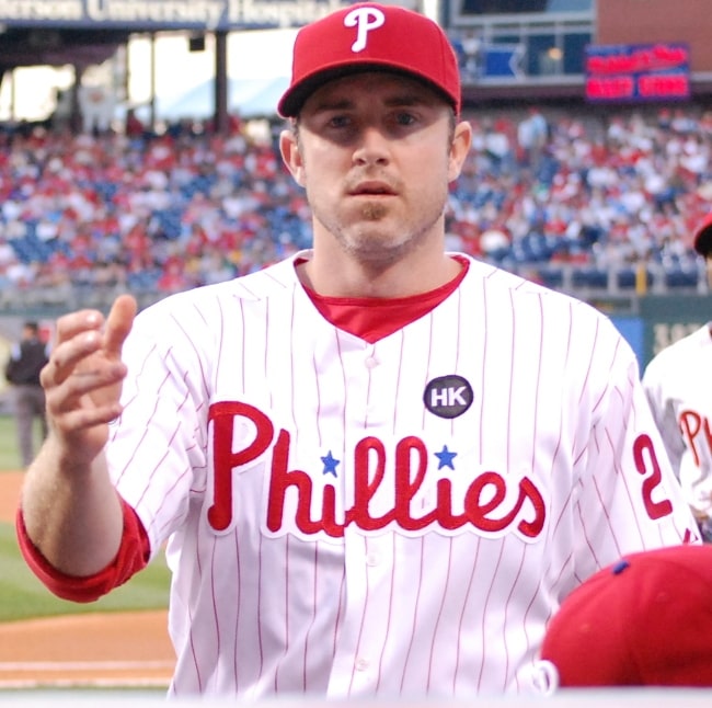 Chase Utley with the Philadelphia Phillies pictured while flipping a ball to a fan during a game on April 21, 2009