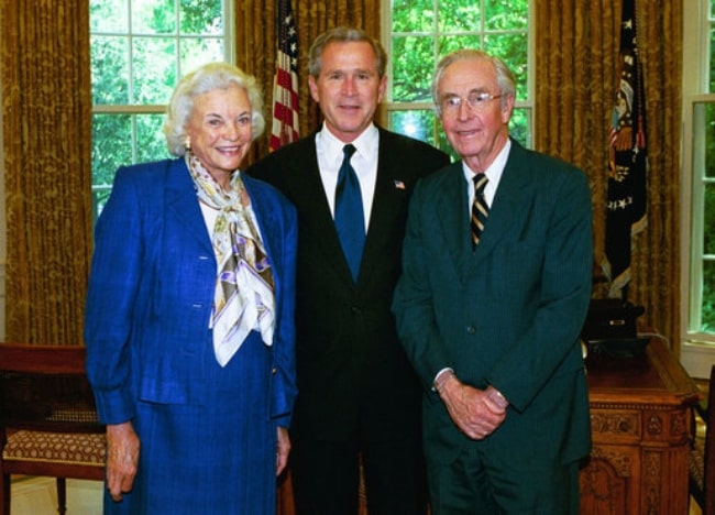 From Left to Right - Sandra Day O'Connor, President George W. Bush, and John O'Connor posing for a picture in the Oval Office in May 2004