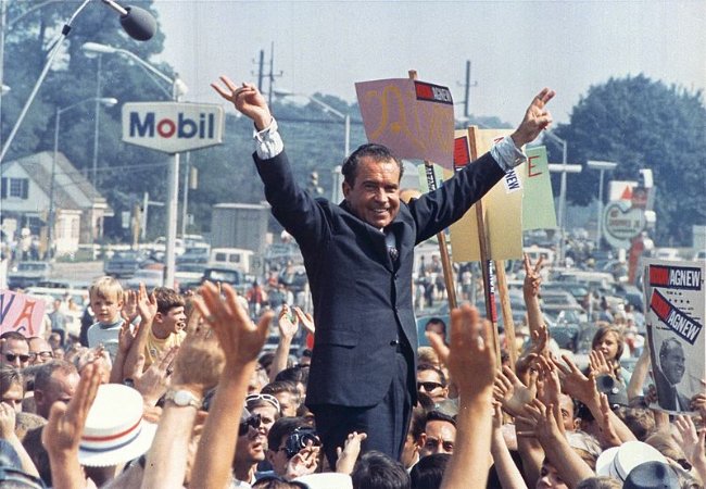 Richard Nixon seen giving his trademark victory sign in 1968