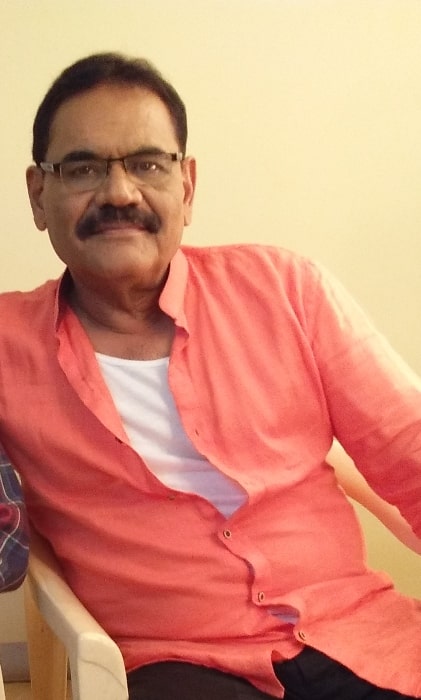 Mushtaq Khan as seen while smiling for a picture in 2018