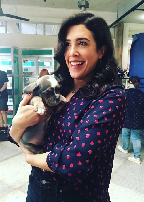 Nicole Power as seen while smiling in a picture while holding a puppy in September 2021