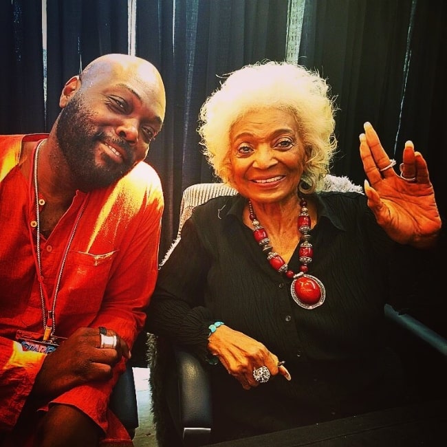 Peter Macon as seen while smiling for a picture with Nichelle Nichols in 2019