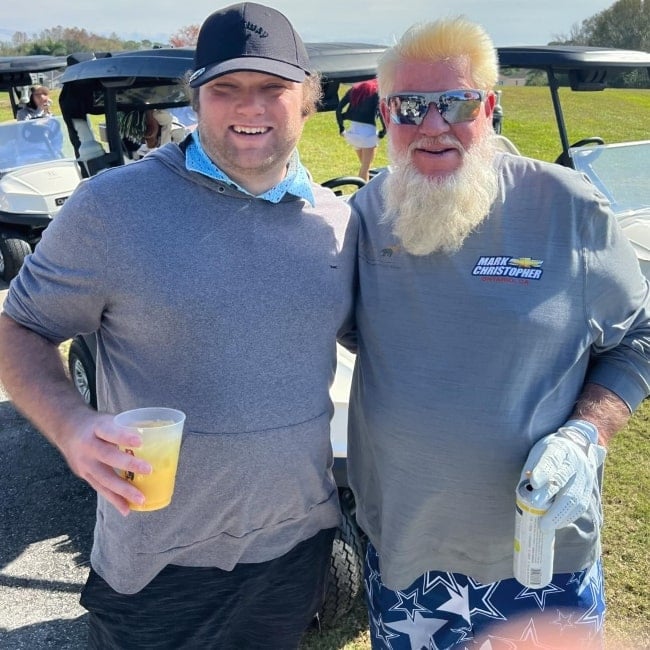 Poofesure as seen in a picture with pro-golfer John Daly that was taken in January 2024