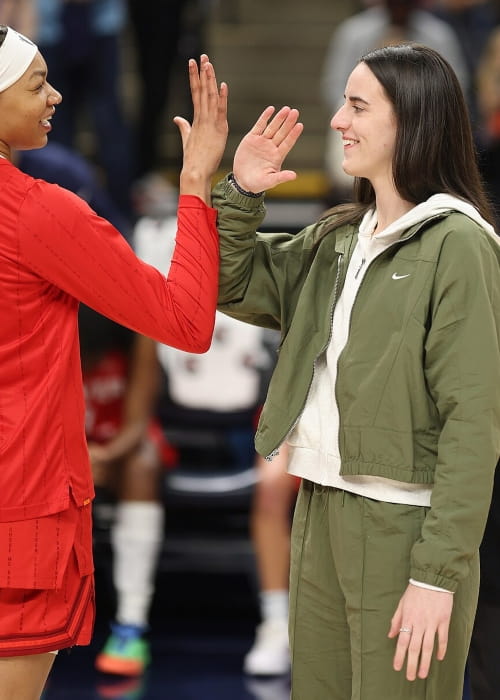 Caitlin Clark celebrates with teammate Makayla Timpson in 2025, while sidelined with an injury